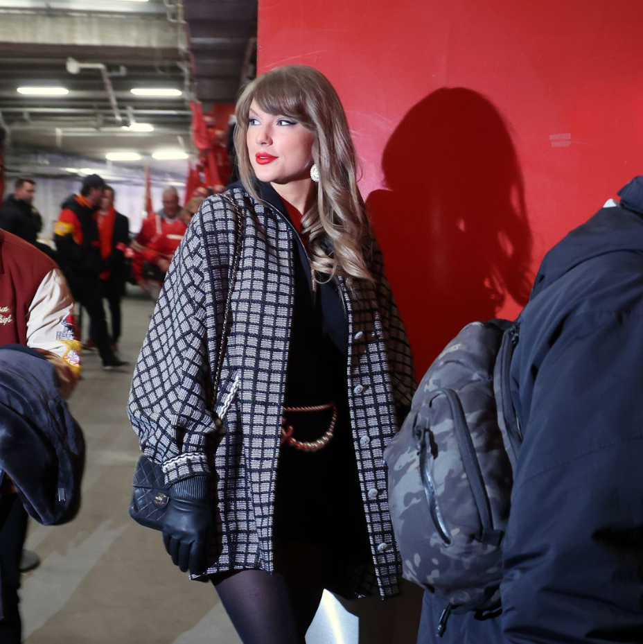 Taylor Swift Wears Checkered Coat And Chanel Belt To Travis Kelce’s Playoff Game Against The Texans