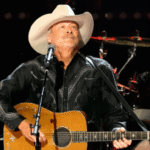 Alan Jackson singing on stage during his farewell tour performance
