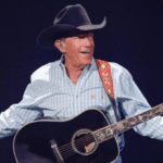 George Strait performing live in a cowboy hat.