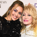 Dolly Parton smiling onstage during a performance